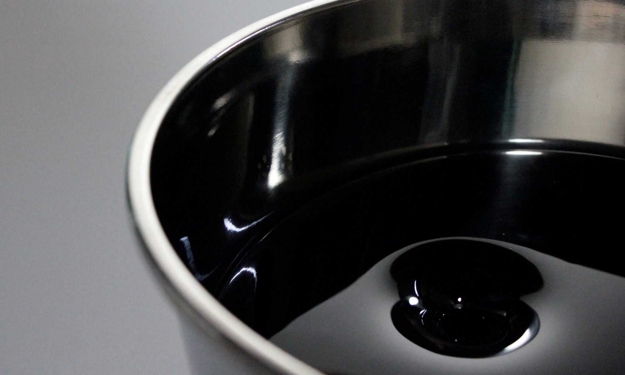 Untitled II. Fused glass looking like black oil in stainless steel buckets