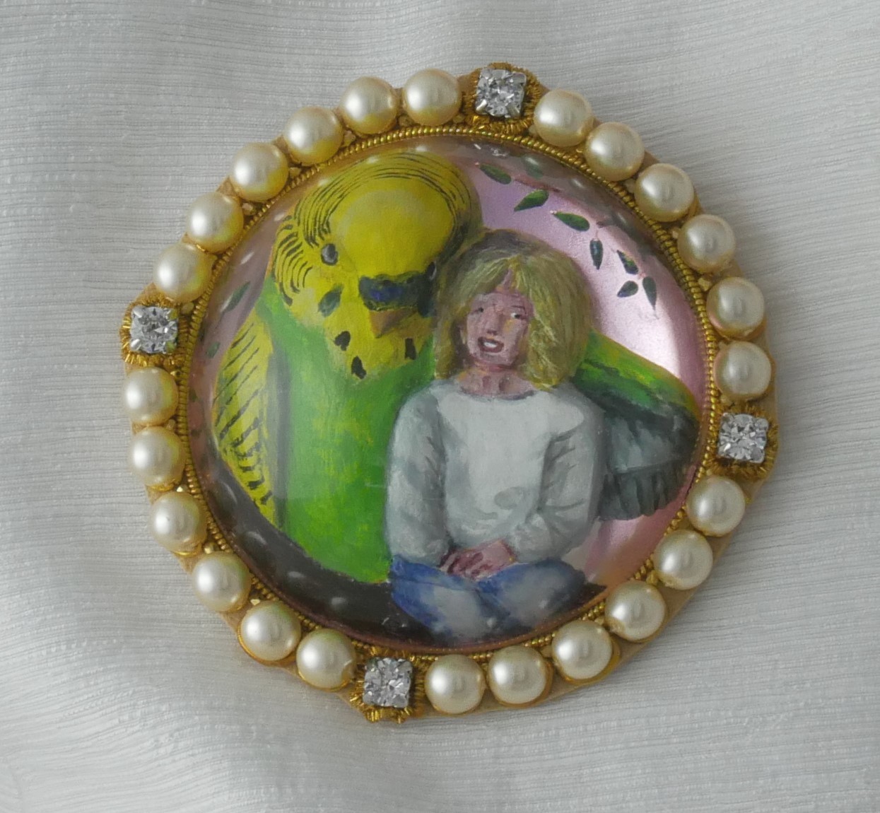 Reverse intaglio cast glass, carved and enamel painted crystal showing a large budieg alongside a small girl
